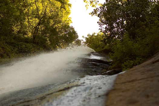 Little waterfall cascading from a gray rock