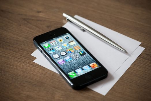 Kiev, Ukraine - January 18, 2013: The new black Apple iPhone 5, sixth generation version of the iPhone is slimmer and lighter model with new high-resolution, 4-inch screen display.