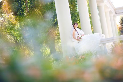 young bride in columns and leaves