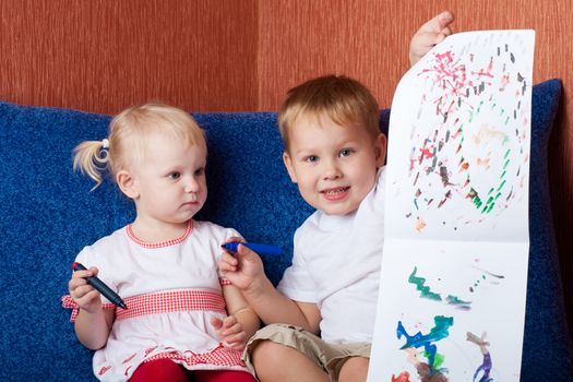 small boy and girl showing painting