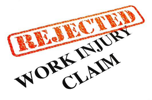 A close-up of a REJECTED Work Injury Claim document.