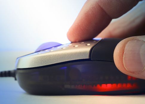 Extreme close-up of hand holding computer mouse