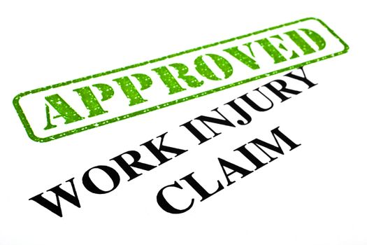 A close-up of an APPROVED Work Injury Claim document.