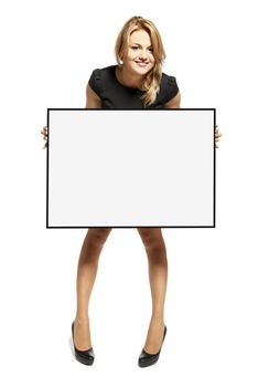 Attractive young woman holding up a poster. Isolated on white background.