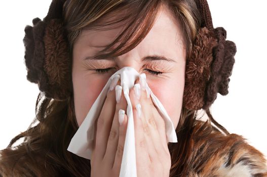 Pale sick woman with a flu, sneezing, in a white background