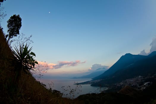 The sun setting over the mountains in lake Atitlan  san Pedro Guatemala.