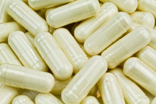 A huge pile of white pills. A huge pile of white pills.