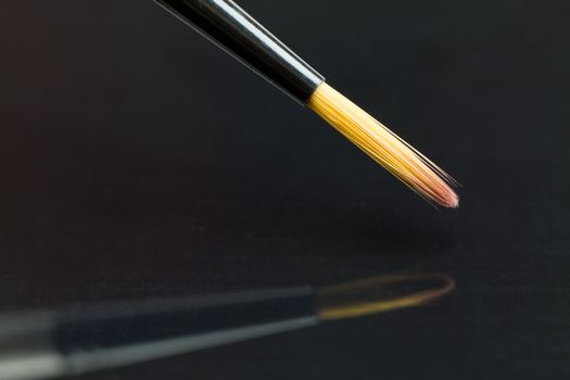 Close up of an artists brush in action.