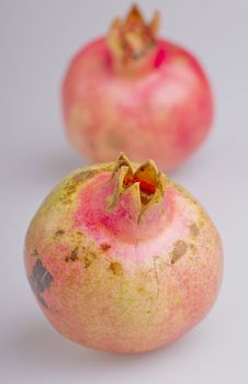 Close up of a pomegranate, with another on the background