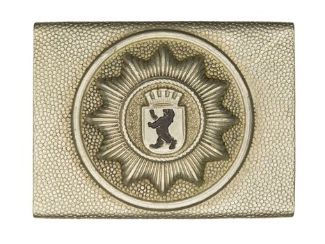 Close-up shot of a army belt buckle with lion symbol on it.