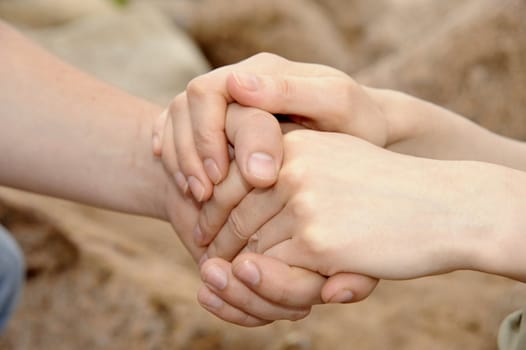 Man's and female hands are fastened together.Taken as closeup.