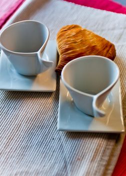 croissant and coffee cup at breakfast