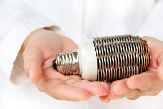 hand holding coin light bulb concept