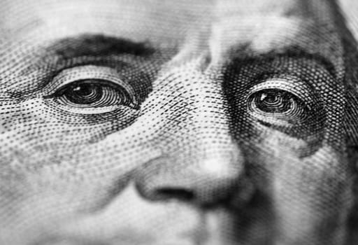 close up of Benjamin Franklin stare on one hundred dollars banknote