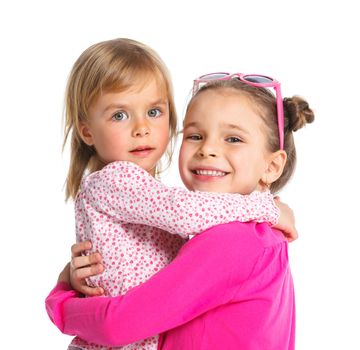 Two happy adorable smiling sisters. Isolated white background