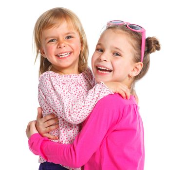 Two happy adorable smiling sisters. Isolated white background