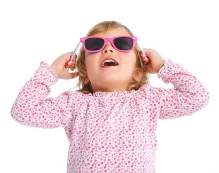 Portrait of little girl in pink dress and sunglasses looking up. Isolated white backround.