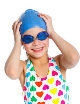 Young girl in swimsuit and swimming goggles over white background