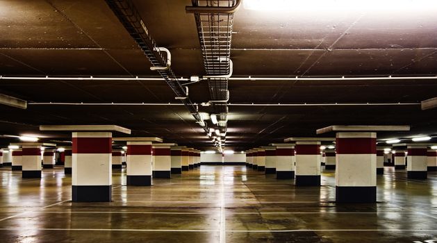 Empty underground parking, reflections on the floor