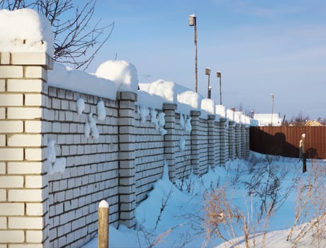 Brick wall, covered with snow in January