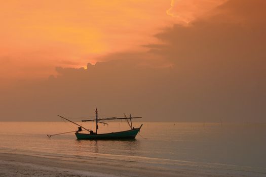 Fishing boat and sunset at the beach.
