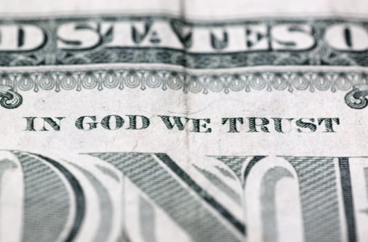 close up of in God we trust motto on 100 dollars