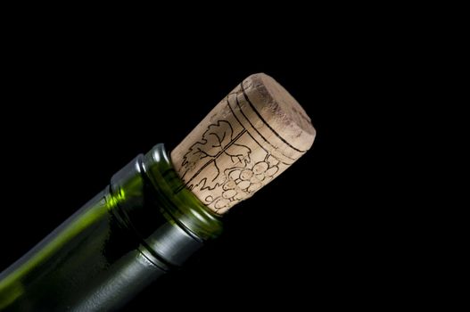 macro photo of wine bottle isolated on a black background