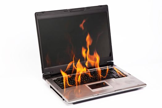 Laptop burning with fire on white background