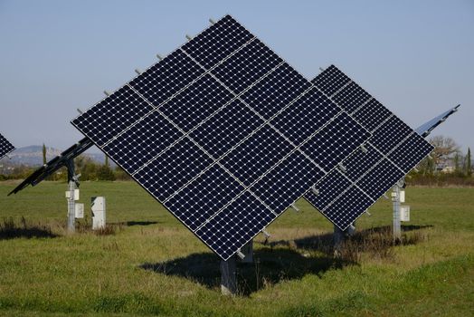 Some solar panels in a green field, a new way to produce energy