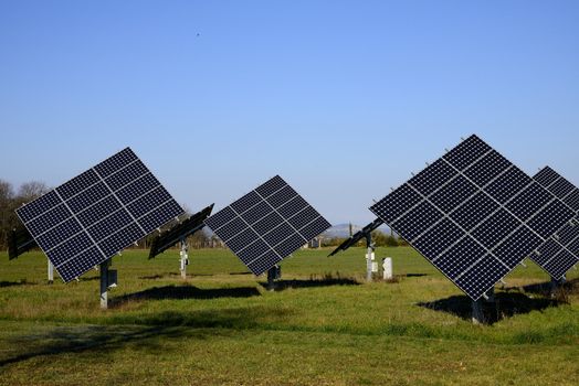 Some solar panels in a green field, a new way to produce energy