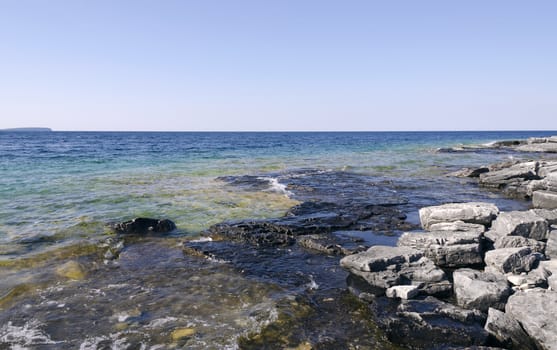 Rock under clear water at shore of Georgian Bay of Lake Huron Ontario