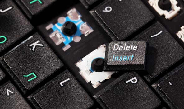 Laptop black keyboard with broken key insert delete