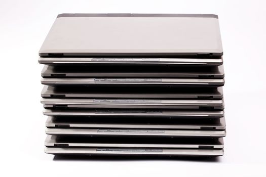 Organized pile of laptops on the white background