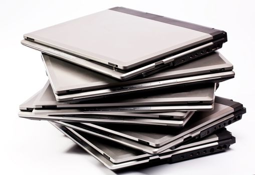 Pile of laptops on the white background