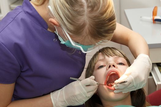 dentist check young girl teeth