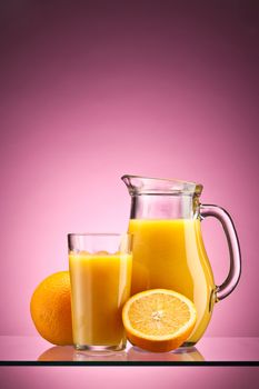 Orange juice over pink with ripe sliced orange