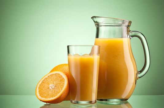 Orange juice over green with ripe sliced orange
