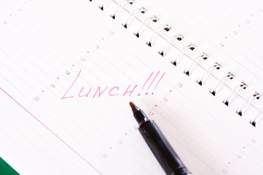 Diary with a reminder of the lunch and red marker