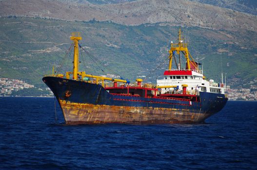 A very rusty small cargo ship anchored near Split, Croatia