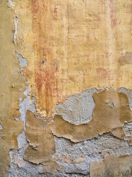 Closed-up image of peeling paint on an aging wall in Tuscany, Italy