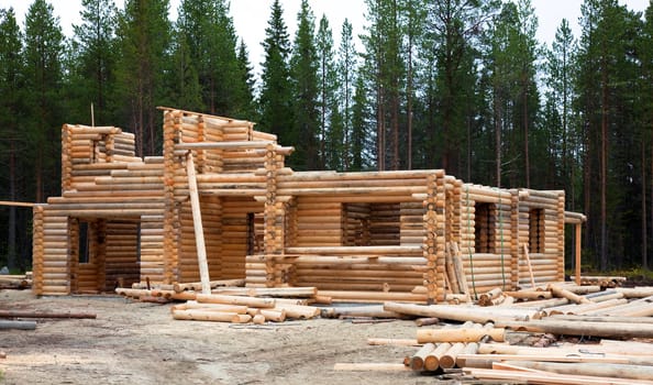 Construction of a two-story log home in the woods