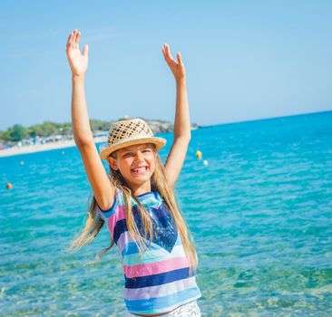 Cute girl in hat on the beach