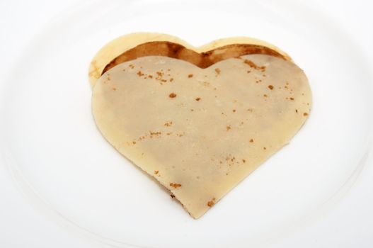 heart-shaped pancake on white plate