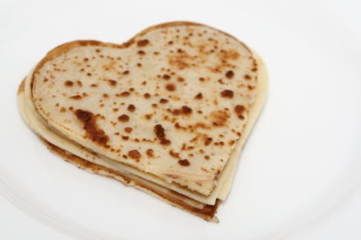 heart-shaped pancakes on white plate