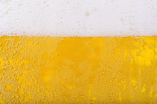 Beer and white froth background. Closeup view.