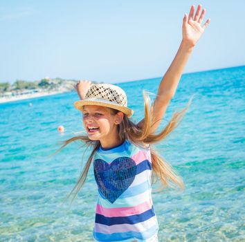 Cute girl in hat on the beach