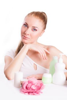 Sensual woman with skincare products isolated on white