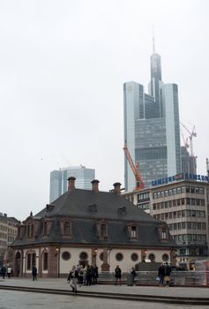 FRANKFURT, GERMANY – FEBRUARY 16, 2013: Hauptwache (guard-house) in downtown Frankfurt am Main, Germany on February 16, 2013. The landmark dates from 1730 and was reconstructed after World War 2. In the background the skyscraper building of Commerzbank is visible.