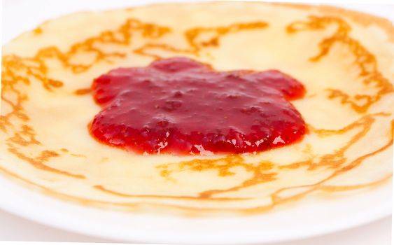 Crepe on white plate with strawberry jam