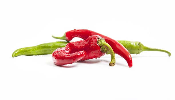 Juicy red and green chili peppers isolated on white